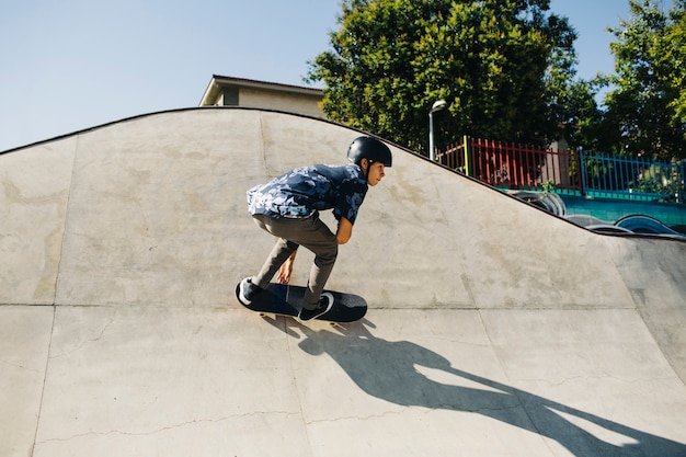 Free photo stylish guy skating outdoors