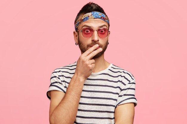 Stylish guy wearing sunglasses and colorful headband