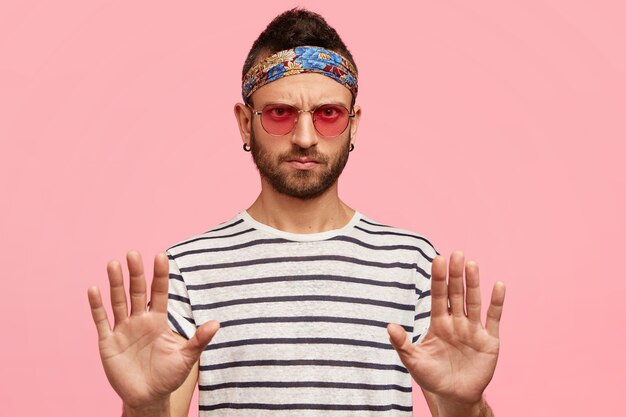 Stylish guy wearing sunglasses and colorful headband