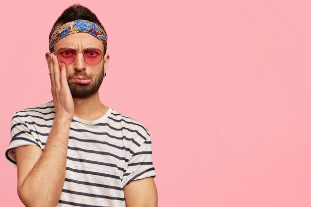 Stylish guy wearing sunglasses and colorful headband