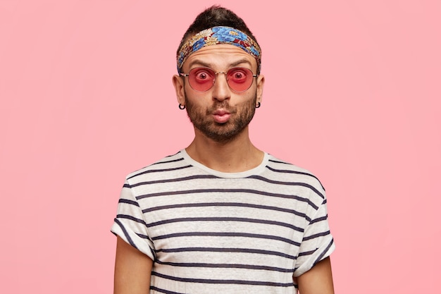 Stylish guy wearing sunglasses and colorful headband