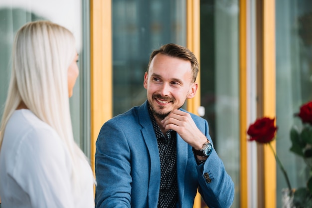 Free photo stylish handsome man looking at blonde young woman