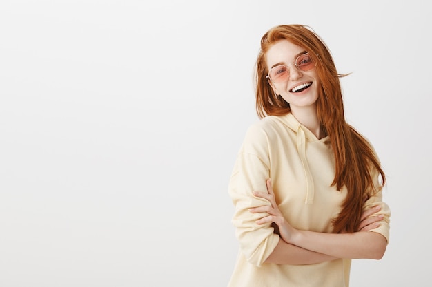 Stylish happy gorgeous redhead girl cross arms chest and smiling