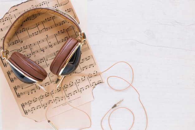 Stylish headphones on sheet music