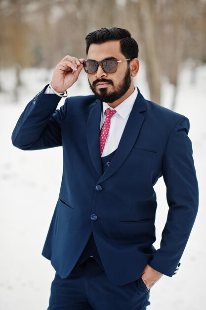 Stylish indian beard business man in suit and sunglasses posed at winter day outdoor