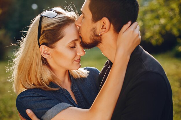 Stylish loving couple standing in a park. 