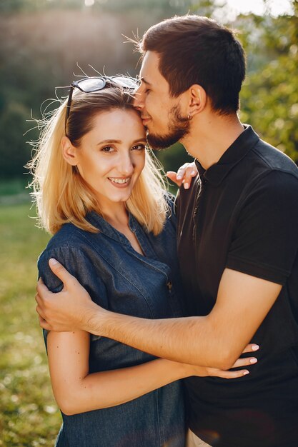 Stylish loving couple standing in a park.