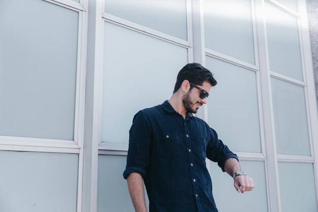 Stylish man checking time on watch