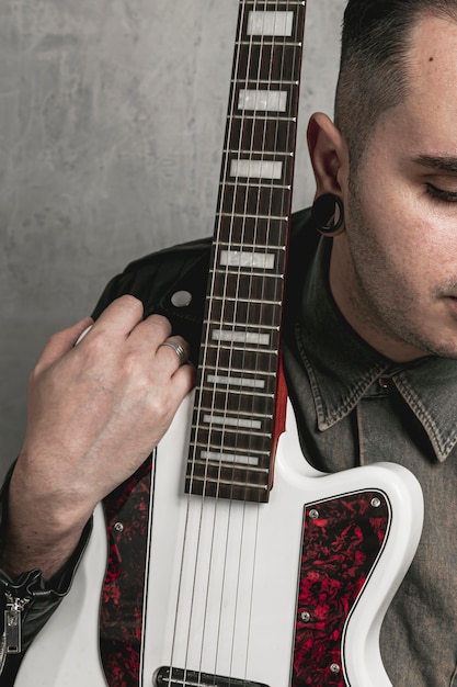 stylish man holding electric guitar
