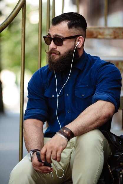 Stylish man listening to music