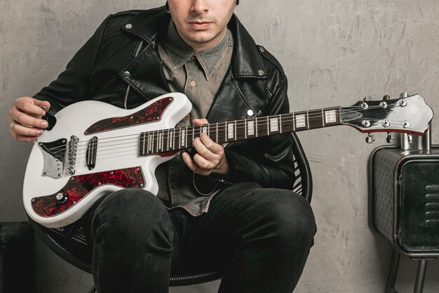 Stylish man playing vintage electric guitar