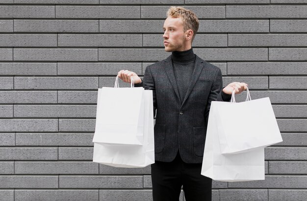 Stylish  man with shopping bags in both hands