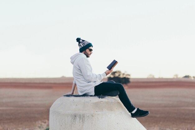 Stylish man with tablet on nature