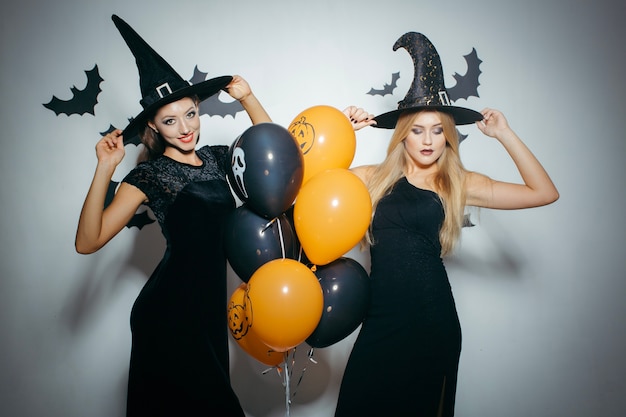 Stylish models in costumes posing in studio