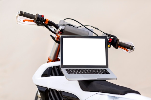 Stylish motorbike with laptop on top in the desert