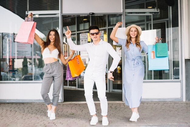 Stylish people posing against shopping mall