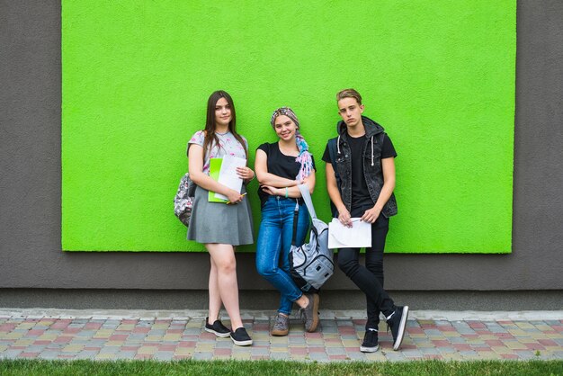 Stylish people with textbooks outside