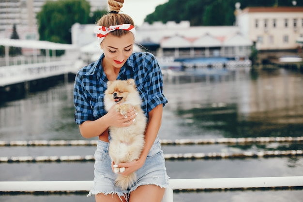 Free photo stylish pin up girl with the little dog