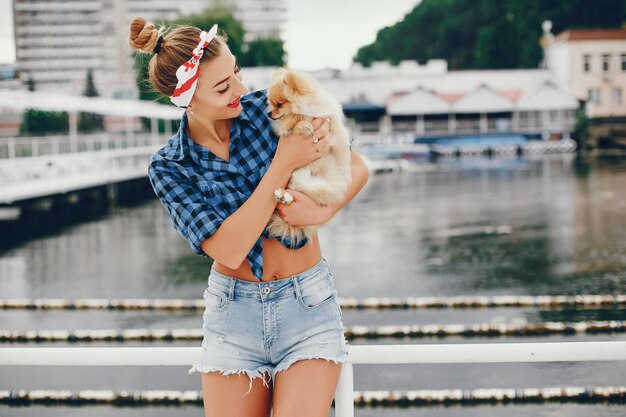Stylish pin up girl with the little dog