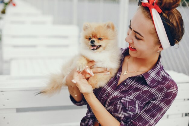 Stylish pin up girl with the little dog