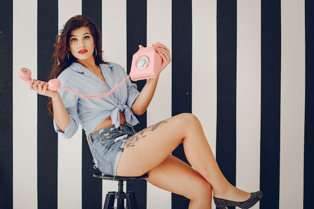 Girl Pinup With Brunette Hair And Retro Make Up With Red Lips In A