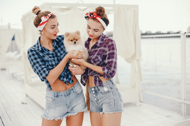 Stylish pin up girls with the little dog