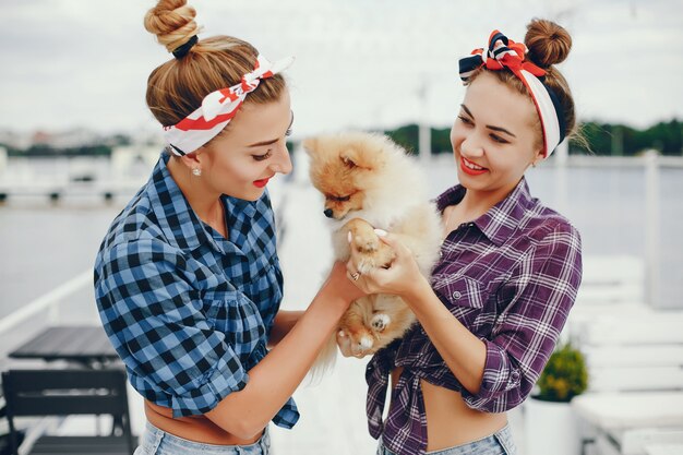 Stylish pin up girls with the little dog