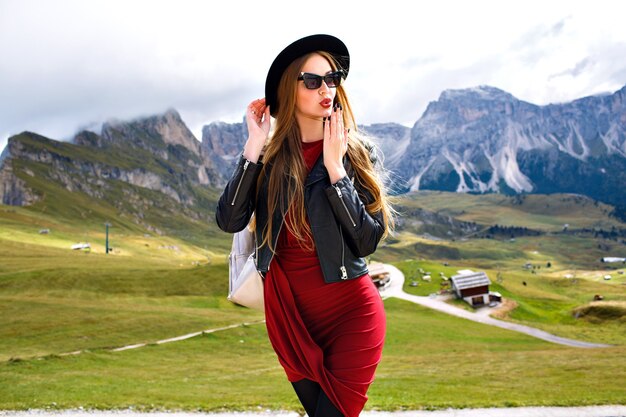 Stylish portrait of elegant woman, posing at Italian Dolomites mountains