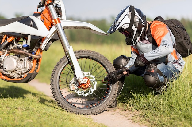 Stylish rider checking wheel pressure