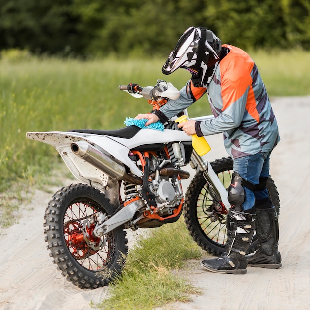 Stylish rider cleaning motorbike