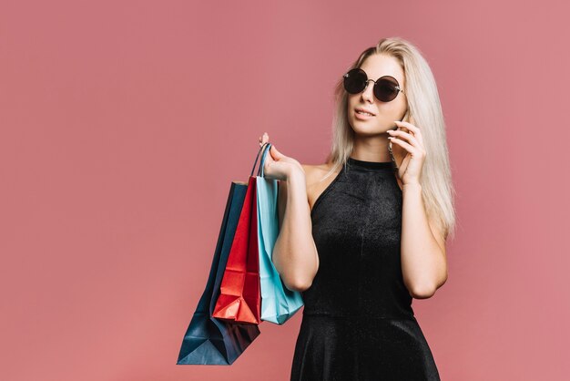 Stylish shopper talking on smartphone 