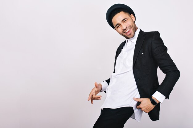Stylish smiled guy in suit, hat having fun. Leisure, cheerful mood, joy, happiness, dancer, modern businessman, isolated.