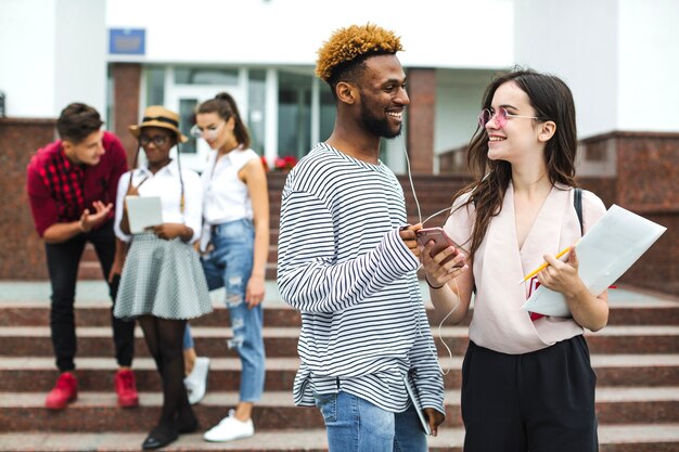 Stylish students listening to music