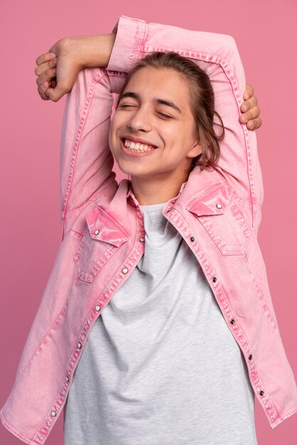 Stylish teen boy in pink posing