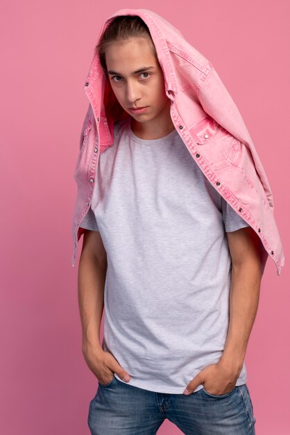 Stylish teen boy in pink posing