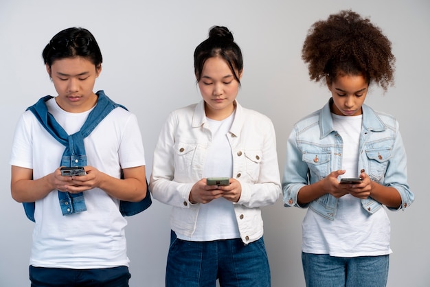 Stylish teen girls and boy posing together