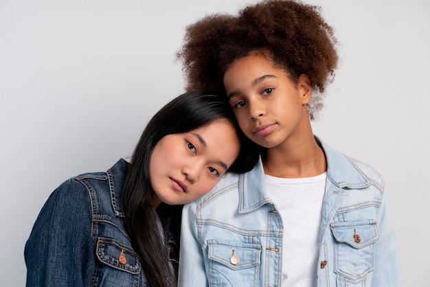 Free photo stylish teen girls posing together