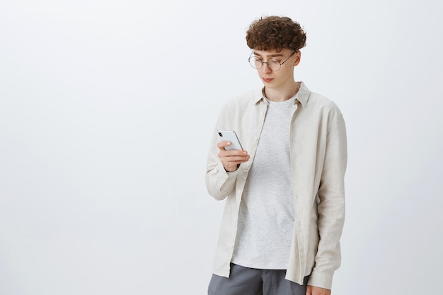 Free photo stylish teenage guy posing against the white wall