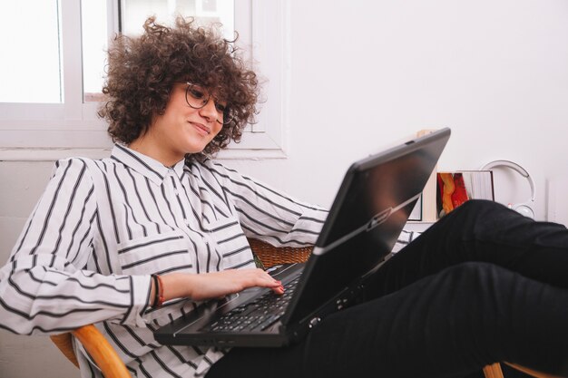 Stylish teenager using laptop