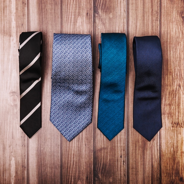 Stylish ties on wooden table