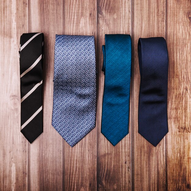 Stylish ties on wooden table