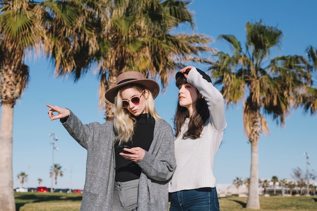 Free photo stylish travelers in sunlight outside