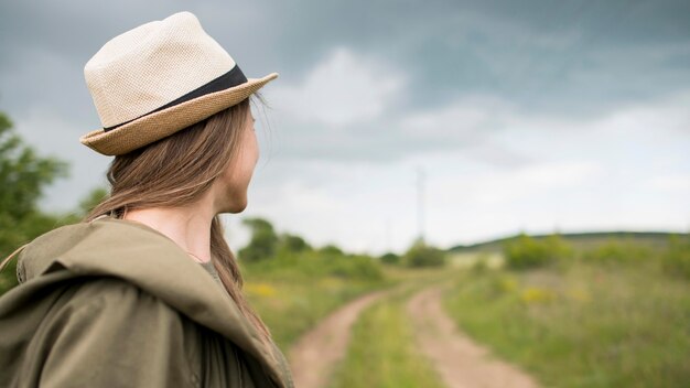 Stylish traveller with hat looking away