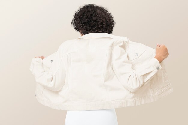 Stylish woman in creamy denim jacket for apparel shoot rear view