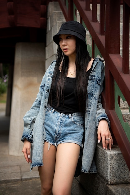 Free photo stylish woman in k-pop clothing in urban scene