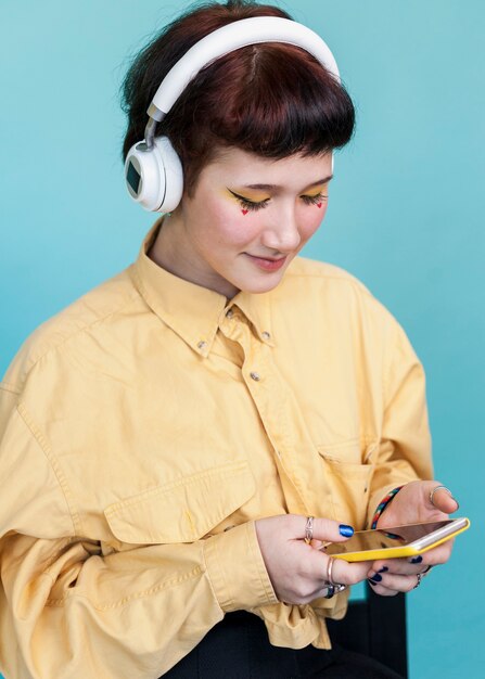 Stylish woman looking at phone studio shot