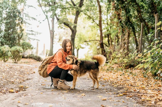 Stylish woman out for a walk with her dog