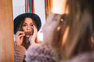 Free photo stylish woman playing harmonica