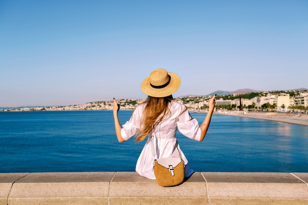 Stylish woman posing back in front of amazing view on Nice