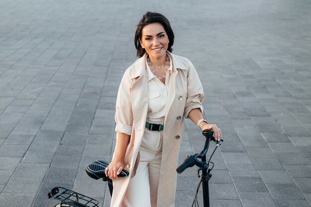 Free photo stylish woman posing with bicycle outdoors